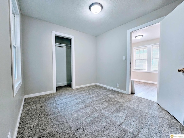 2715 S 15th St, Omaha, NE 68108 - unfurnished bedroom with carpet, a textured ceiling, and a closet