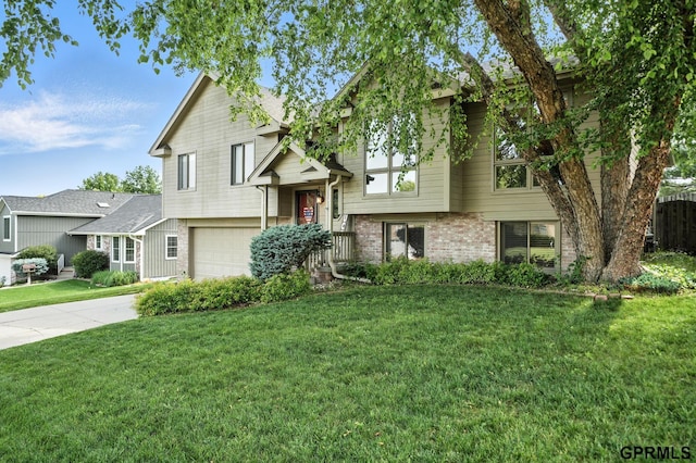 2303 N 150th Ave, Omaha, NE 68116 - view of front of property with an attached garage, brick siding, a front yard, and concrete driveway
