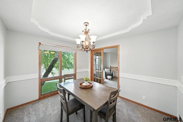 2303 N 150th Ave, Omaha, NE 68116 - dining space featuring a chandelier, carpet floors, a tray ceiling, and a textured ceiling
