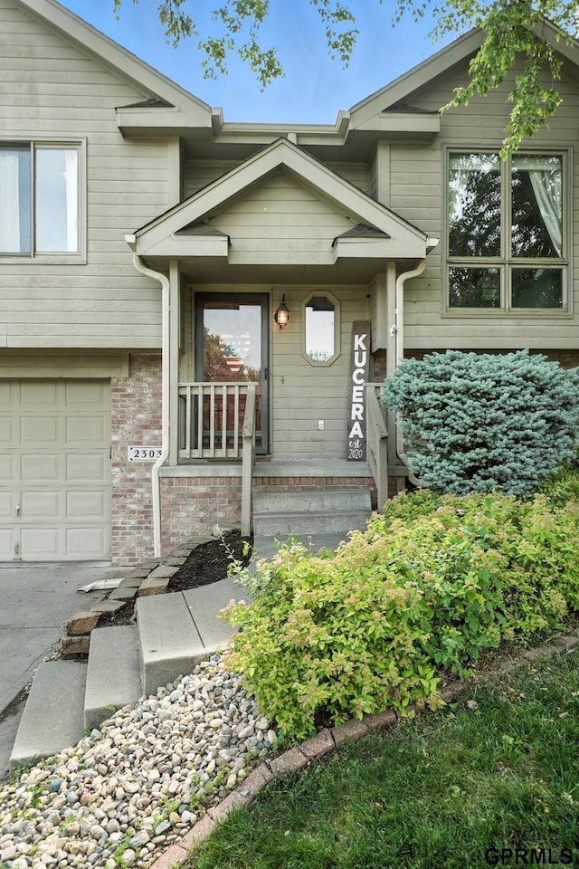 2303 N 150th Ave, Omaha, NE 68116 - entrance to property with an attached garage and a porch