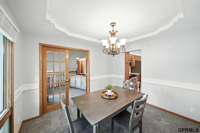 2303 N 150th Ave, Omaha, NE 68116 - dining area featuring a chandelier, carpet floors, a raised ceiling, and a textured ceiling