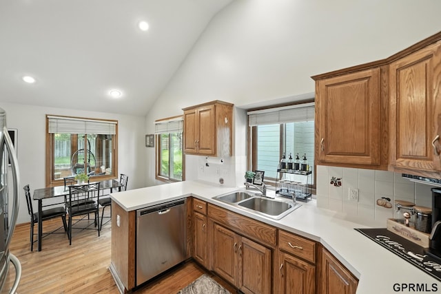 2303 N 150th Ave, Omaha, NE 68116 - kitchen with dishwasher, tasteful backsplash, brown cabinets, light wood-style floors, and recessed lighting
