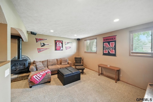 2303 N 150th Ave, Omaha, NE 68116 - carpeted living room featuring a wood stove, recessed lighting, and a textured ceiling