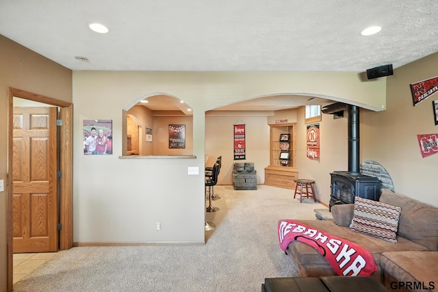 2303 N 150th Ave, Omaha, NE 68116 - living area with arched walkways, a wood stove, carpet flooring, and recessed lighting