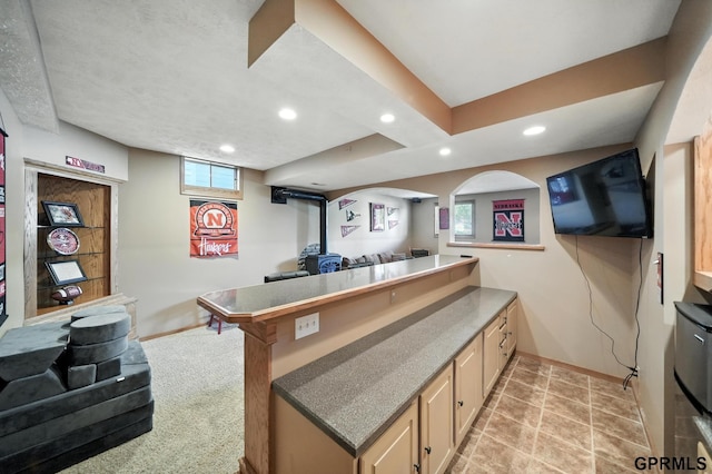 2303 N 150th Ave, Omaha, NE 68116 - kitchen featuring a peninsula, recessed lighting, open floor plan, a wood stove, and light brown cabinetry