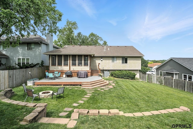 2303 N 150th Ave, Omaha, NE 68116 - rear view of house featuring a fire pit, a deck, a sunroom, and a fenced backyard
