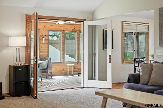 2303 N 150th Ave, Omaha, NE 68116 - doorway to outside with carpet floors, wood walls, vaulted ceiling, and french doors