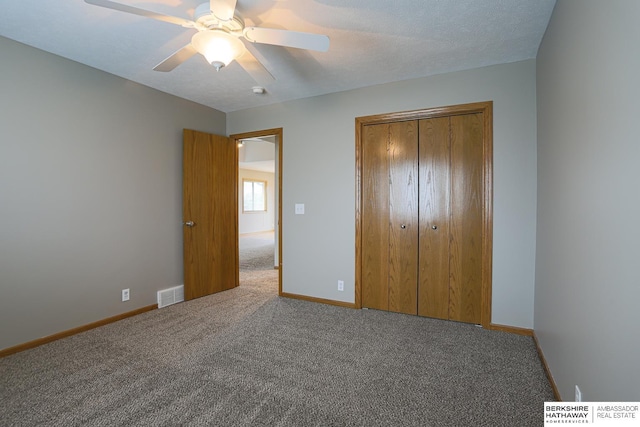 32 Huron Cir, Council Bluffs, IA 51501 - unfurnished bedroom with carpet, a closet, and ceiling fan