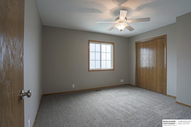32 Huron Cir, Council Bluffs, IA 51501 - unfurnished bedroom featuring carpet, a closet, and a ceiling fan