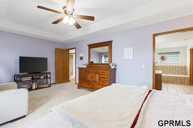 16404 Polk St, Omaha, NE 68135 - bedroom featuring light carpet, ensuite bathroom, a raised ceiling, and ceiling fan