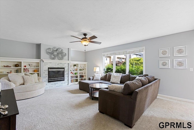 16404 Polk St, Omaha, NE 68135 - carpeted living area with ceiling fan, a fireplace, and a textured ceiling