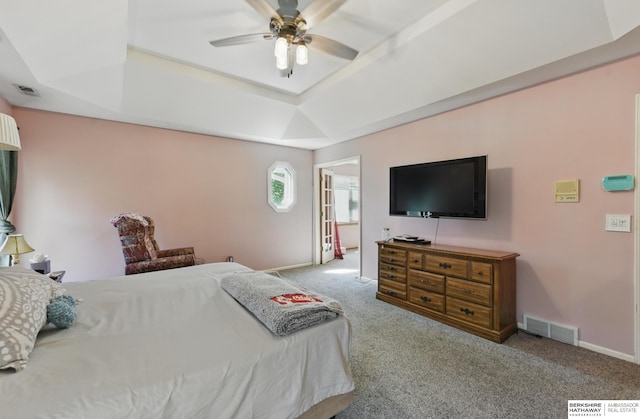 1326 Bellevue Blvd, Bellevue, NE 68005 - carpeted bedroom featuring a tray ceiling and a ceiling fan
