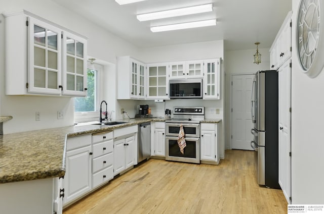 1326 Bellevue Blvd, Bellevue, NE 68005 - kitchen featuring appliances with stainless steel finishes, white cabinetry, light wood-style floors, and light stone countertops