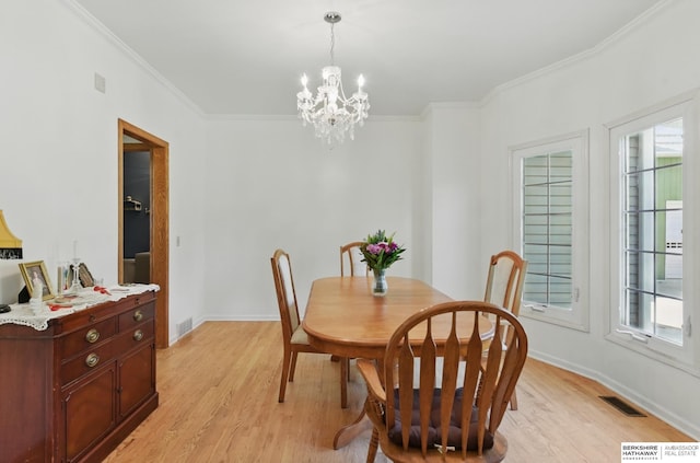 1326 Bellevue Blvd, Bellevue, NE 68005 - dining space featuring light wood finished floors, a chandelier, and ornamental molding