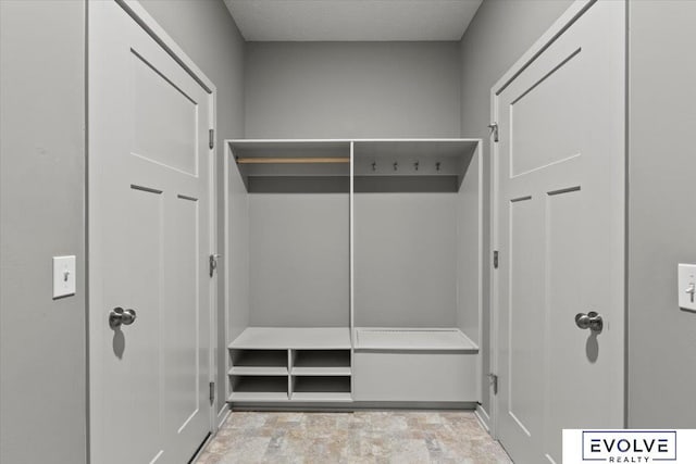 12040 S 44th St, Bellevue, NE 68123 - mudroom with stone finish flooring and a textured ceiling