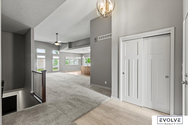 12040 S 44th St, Bellevue, NE 68123 - hall with a chandelier, an upstairs landing, a textured ceiling, and wood finished floors