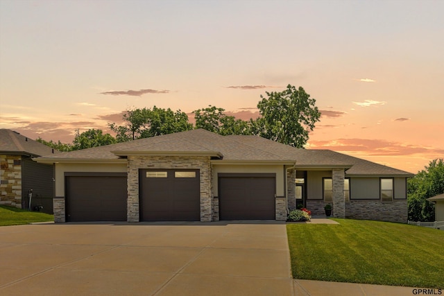 2111 Gindy Dr, Bellevue, NE 68147 - prairie-style home featuring a garage, a lawn, driveway, and stone siding