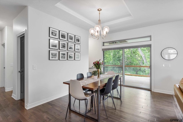 2111 Gindy Dr, Bellevue, NE 68147 - dining space featuring a tray ceiling, dark wood-type flooring, a chandelier, and crown molding