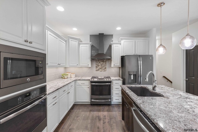 2111 Gindy Dr, Bellevue, NE 68147 - kitchen featuring wall chimney exhaust hood, appliances with stainless steel finishes, dark wood-style flooring, white cabinetry, and recessed lighting