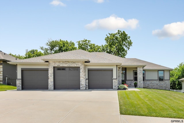 2111 Gindy Dr, Bellevue, NE 68147 - prairie-style house featuring an attached garage, stone siding, concrete driveway, a front lawn, and roof with shingles