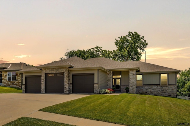 2111 Gindy Dr, Bellevue, NE 68147 - prairie-style house with stone siding, an attached garage, a front yard, and driveway