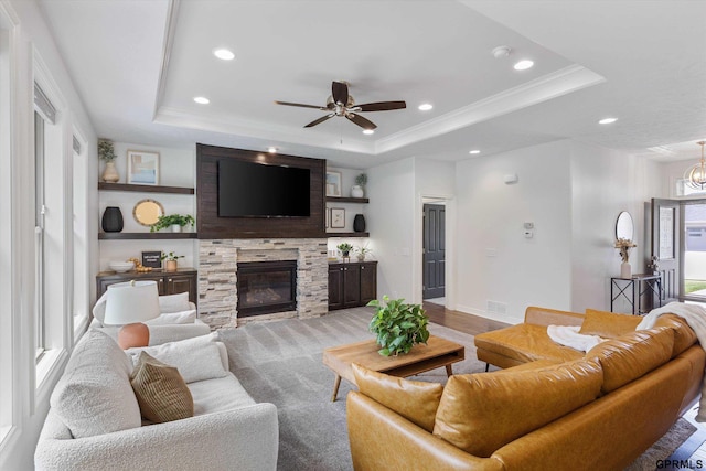 2111 Gindy Dr, Bellevue, NE 68147 - living area with a raised ceiling, a ceiling fan, a stone fireplace, recessed lighting, and ornamental molding
