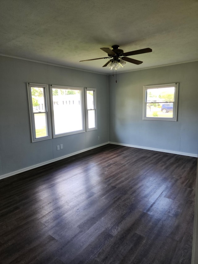 1653 E 3rd St, Fremont, NE 68025 - empty room featuring dark wood finished floors, ceiling fan, and crown molding