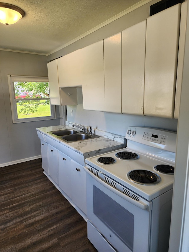 1653 E 3rd St, Fremont, NE 68025 - kitchen featuring white range with electric stovetop, dark wood finished floors, a textured ceiling, white cabinetry, and ornamental molding
