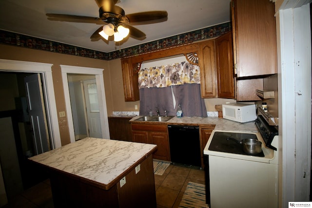 315 N Main St, Wilber, NE 68465 - kitchen with black dishwasher, white microwave, stove, ceiling fan, and light countertops