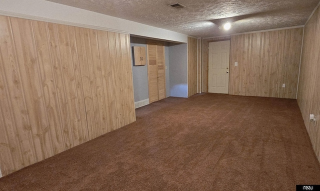 7512 Susan Ave S, La Vista, NE 68128 - carpeted empty room featuring wood walls and a textured ceiling