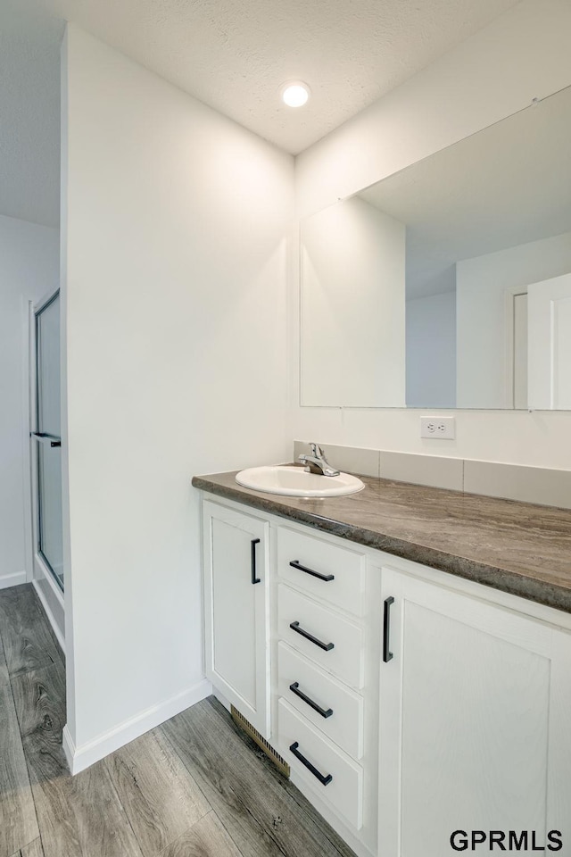 2507 Murray Rd, Plattsmouth, NE 68048 - full bath featuring vanity, wood finished floors, and an enclosed shower