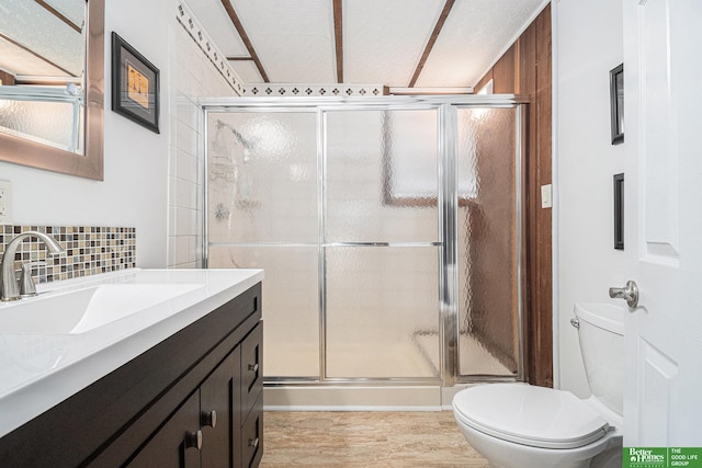 9109 Murray Dr, Plattsmouth, NE 68048 - full bath with backsplash, vanity, a stall shower, and wood finished floors