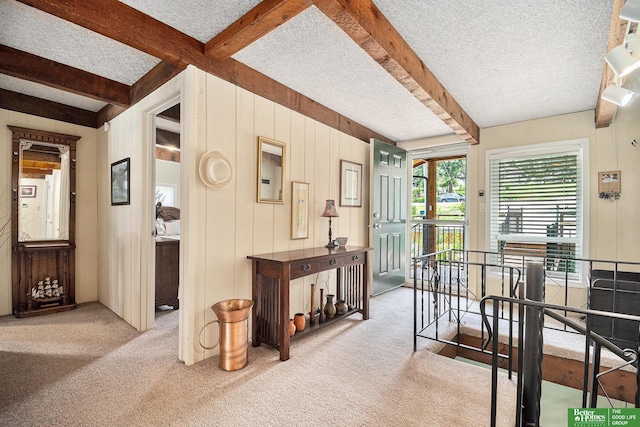 9109 Murray Dr, Plattsmouth, NE 68048 - hallway featuring carpet floors, beamed ceiling, a textured ceiling, an upstairs landing, and wooden walls