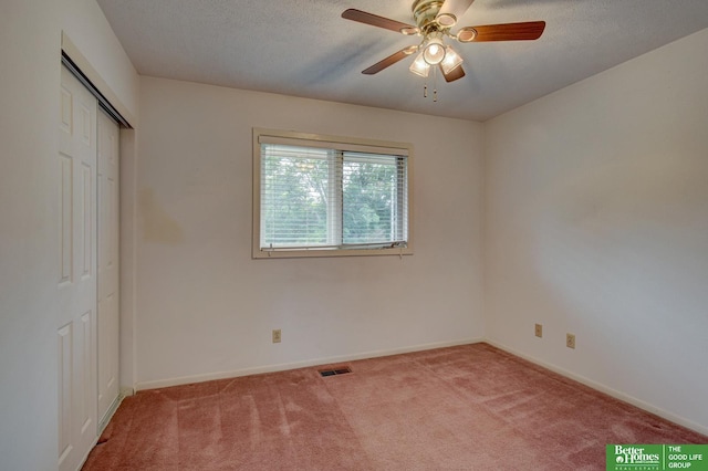 2530 S 148th St, Omaha, NE 68144 - unfurnished bedroom featuring light colored carpet, a textured ceiling, a closet, and ceiling fan