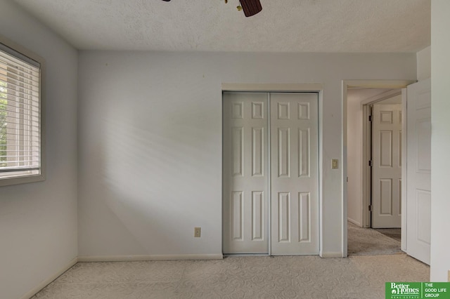 2530 S 148th St, Omaha, NE 68144 - unfurnished bedroom featuring carpet floors, a closet, a textured ceiling, and ceiling fan