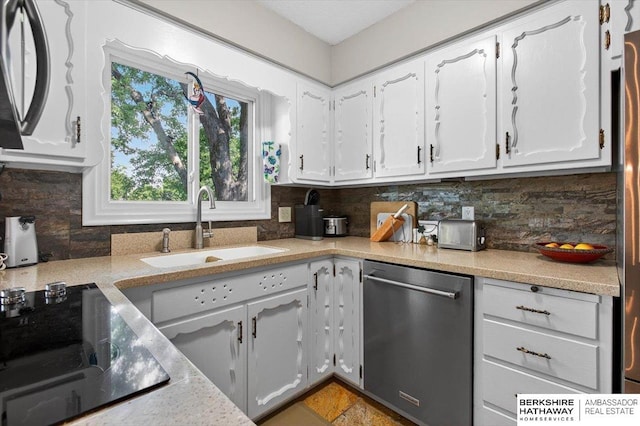 247 N 117th Ave, Omaha, NE 68154 - kitchen with stainless steel dishwasher, white cabinetry, black electric cooktop, light countertops, and decorative backsplash
