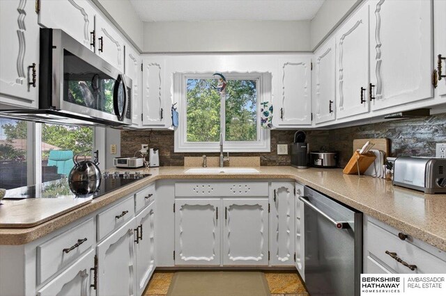 247 N 117th Ave, Omaha, NE 68154 - kitchen featuring stainless steel appliances, white cabinets, backsplash, and light countertops