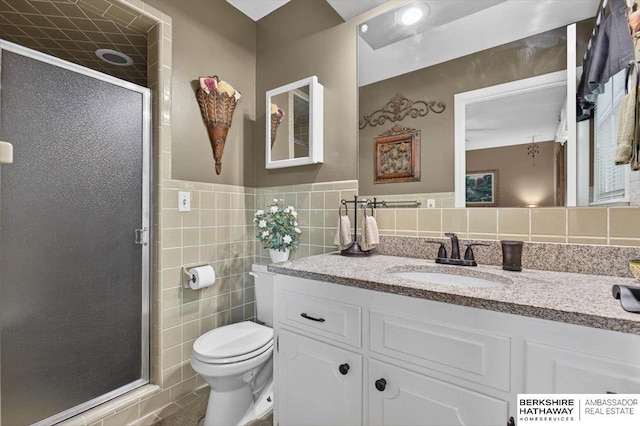 247 N 117th Ave, Omaha, NE 68154 - bathroom with tile walls, vanity, a shower stall, and a wainscoted wall