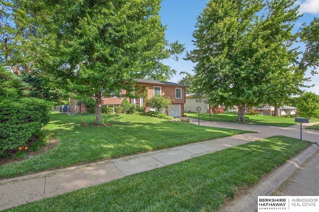 247 N 117th Ave, Omaha, NE 68154 - view of front of home with a garage, a front yard, and concrete driveway