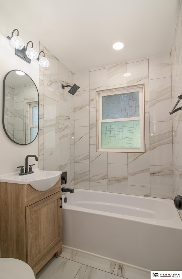 3772 F St, Lincoln, NE 68510 - bathroom featuring vanity,  shower combination, marble look tiles, and recessed lighting