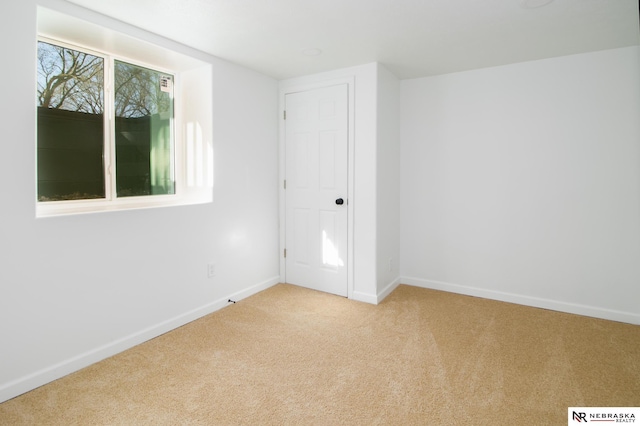 3772 F St, Lincoln, NE 68510 - unfurnished bedroom featuring light colored carpet and baseboards