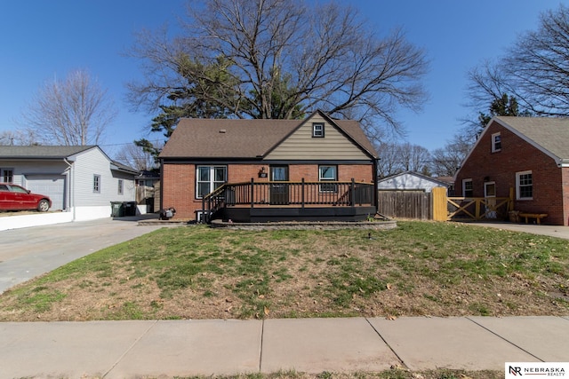 3772 F St, Lincoln, NE 68510 - view of front of home featuring brick siding, a wooden deck, and driveway