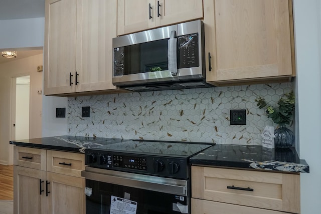 3772 F St, Lincoln, NE 68510 - kitchen with stainless steel microwave, electric range oven, light brown cabinetry, and decorative backsplash