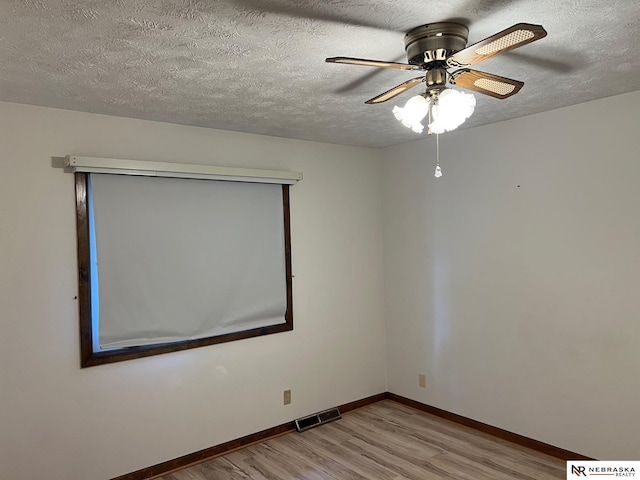 6211 S 150th St, Omaha, NE 68137 - empty room featuring wood finished floors, a ceiling fan, and a textured ceiling