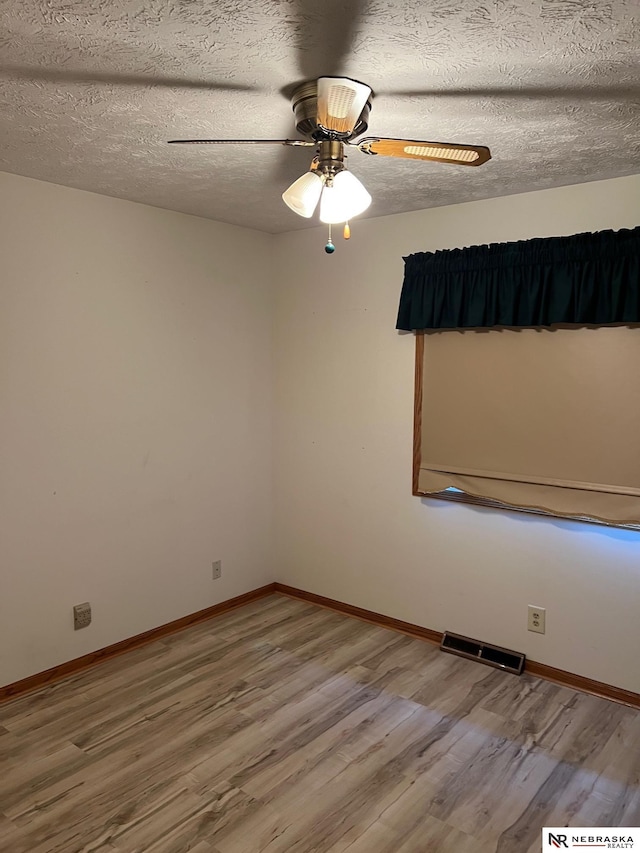 6211 S 150th St, Omaha, NE 68137 - spare room with wood finished floors, a ceiling fan, and a textured ceiling