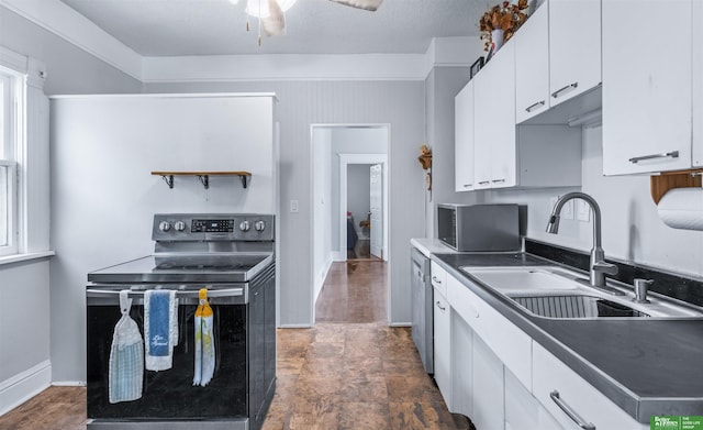 13130 N St N, Omaha, NE 68137 - kitchen with electric range oven, white cabinetry, dark countertops, ceiling fan, and stainless steel dishwasher