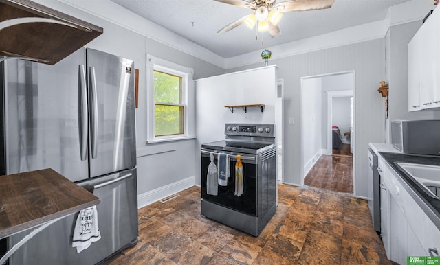 13130 N St N, Omaha, NE 68137 - kitchen featuring appliances with stainless steel finishes, ceiling fan, white cabinets, and dark stone finish flooring