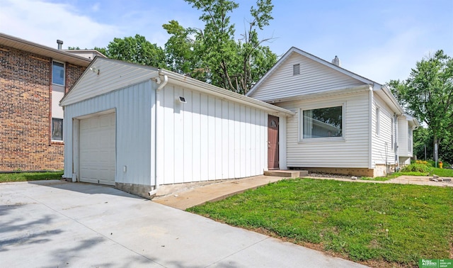 13130 N St N, Omaha, NE 68137 - view of front facade featuring driveway, a front lawn, a detached garage, and an outbuilding