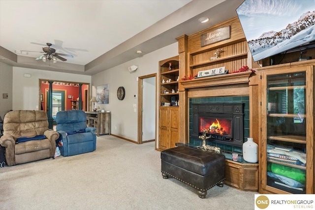 3521 N 267th Plz, Waterloo, NE 68069 - carpeted living room featuring a fireplace, ceiling fan, and a raised ceiling