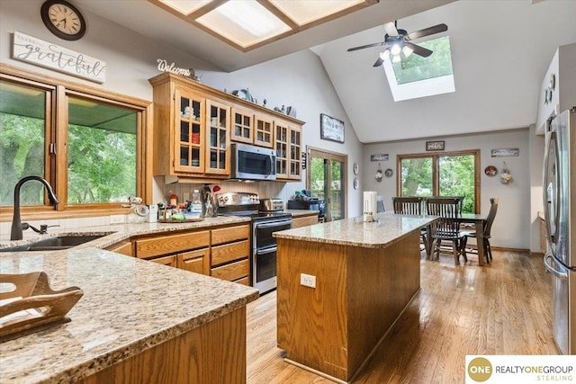 3521 N 267th Plz, Waterloo, NE 68069 - kitchen featuring stainless steel appliances, a skylight, a center island, high vaulted ceiling, and ceiling fan